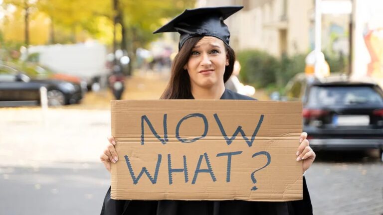 Student Holding Now What Sign